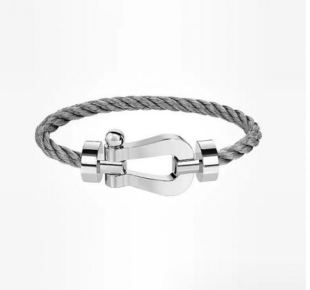 A close-up of a stainless steel wire bangle bracelet featuring a rope-like design and a nautical knot clasp.