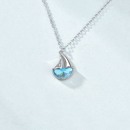 925 Sterling Silver CZ Sailboat Pendant Necklace Set of 5 - Close-up of a 925 sterling silver sailboat pendant necklace, featuring a light blue CZ gemstone hull and sparkling white CZ stones on the sail.