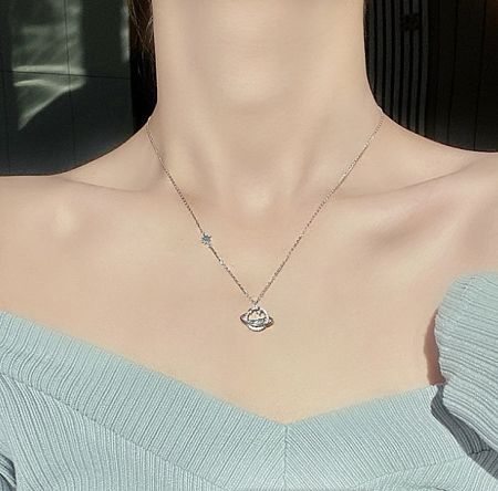 Detailed view of the 925 Sterling Silver Star Moon Space Necklace pendant.