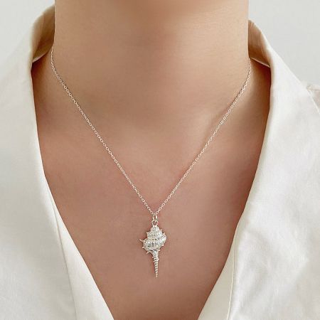Model wearing the S925 sterling silver seashell necklace, showcasing its elegant look.