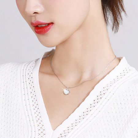 Lifestyle image of the silver shell necklace, perfect for everyday elegance.