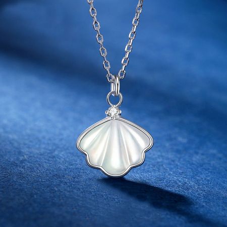 Detailed view of the sterling silver shell pendant, highlighting its lustrous finish and crystal accent.