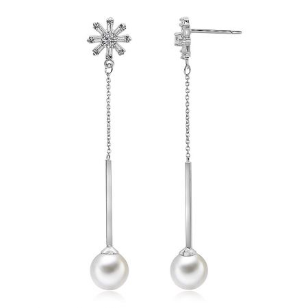 Detailed shot of the silver snowflake pearl earrings highlighting the post and clasp closure.