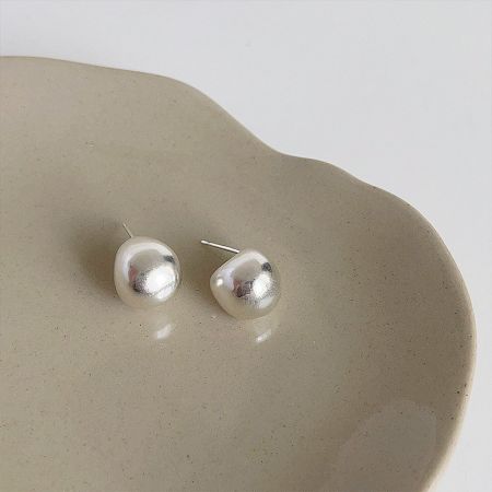 Detailed close-up of the silver-plated small pea button stud earring.