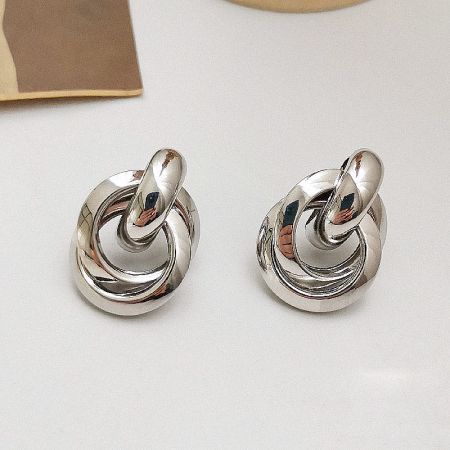 Detailed shot of the silver twisted spiral earrings highlighting the metallic sheen.