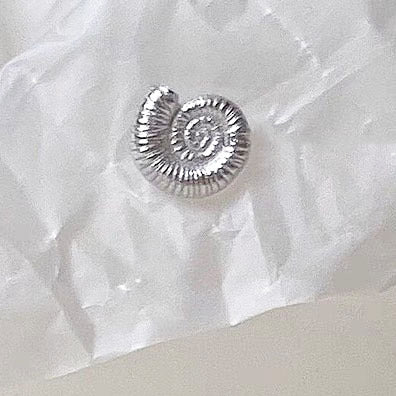 Another design from the asymmetrical sea shell earring set, showing intricate spiral details.