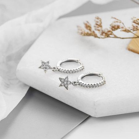 The silver variant of the celestial pavé star hoop earrings, shown against a clean white background.