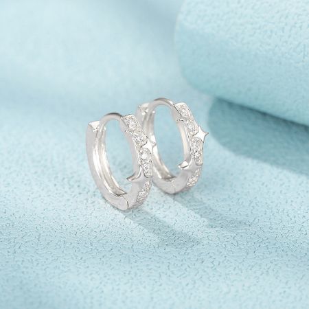 925 Sterling Silver 9mm Star Zircon CZ Hoop Huggie Earrings - A pair of 925 sterling silver star-shaped hoop huggie earrings, featuring sparkling zircon CZ stones, displayed on a light blue background.
