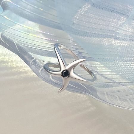 Detailed view of the intricate starfish design on the sterling silver ring.