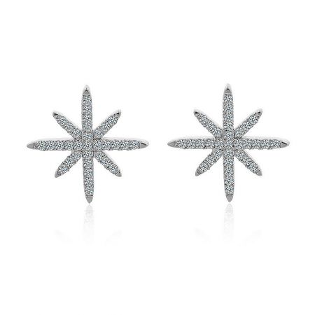 Starburst Stud Earrings In Rhodium - A pair of silver starburst stud earrings in rhodium, featuring an eight-pointed star design set with sparkling cubic zirconia stones, shown on a white background.