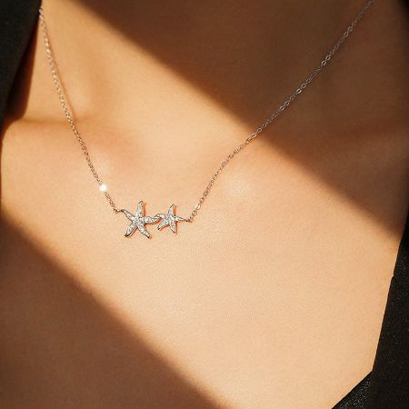 Full view of the sterling silver starfish necklace, showcasing its delicate chain and multiple pendants.