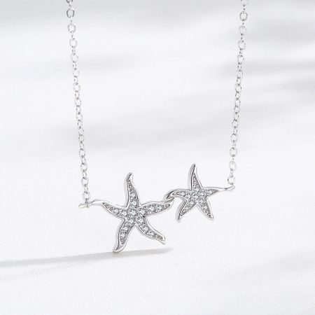 925 Sterling Silver Ocean Sea Two Zirconia Starfish Pendant Necklace Set - A detailed view of the 925 Sterling Silver Starfish Pendant Necklace, highlighting the two pendants adorned with brilliant clear zirconia gemstones.