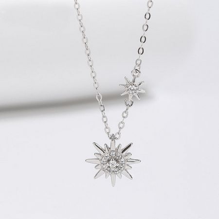 925 Sterling Silver Sparkling Starburst Double Sun Necklace - A detailed studio shot of the 925 sterling silver sparkling starburst double sun necklace, showcasing its two intricate pendants with clear gemstones.