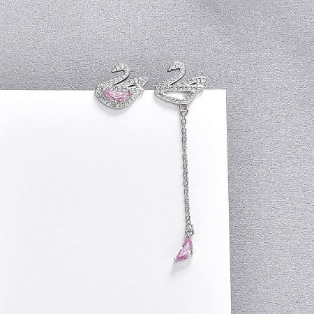 Close-up of the silver swan earrings featuring clear and pink crystal details.
