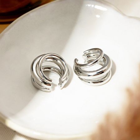 Side view of the silver swirl ear cuff, highlighting its unique shape.