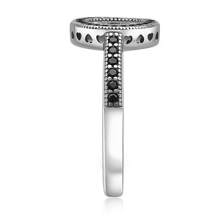 Detailed shot of the silver ring, showing the unique T-shaped silhouette and intricate heart cutouts.