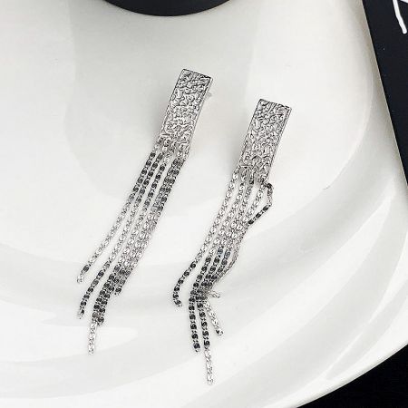 Detailed studio shot of the sterling silver tassel earrings, highlighting the textured rectangular top.