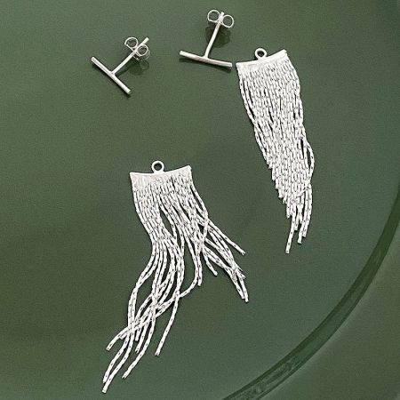 Close-up of the earring posts and butterfly backs of the silver tassel earrings.
