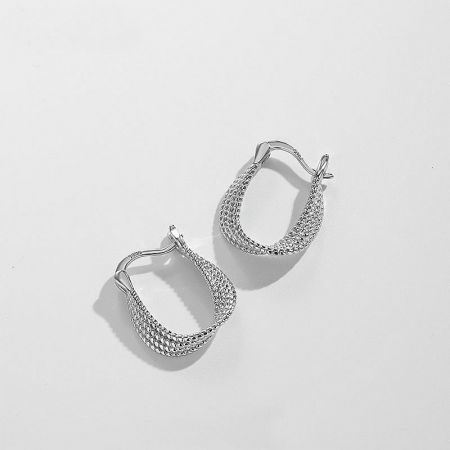 Detailed studio shot of the sterling silver twisted hoop earring, emphasizing the intricate woven pattern.