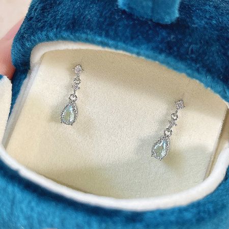 The silver plated zircon earrings presented in a luxurious blue velvet box.