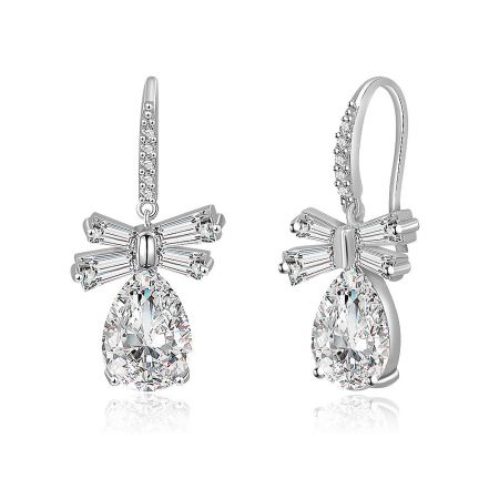 Detailed close-up of the White CZ Oval Drop Bow Earrings, highlighting the intricate bow top and the quality of the silver-toned metal.