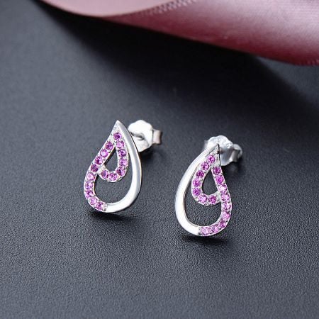 Close-up of the teardrop stud earrings featuring delicate pink cubic zirconia gemstones.