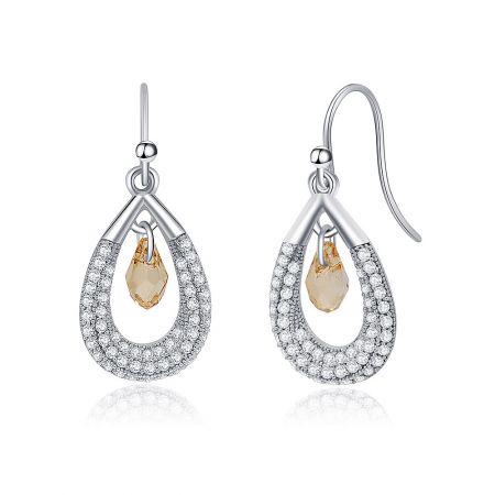 Close-up shot of the Swarovski crystal teardrop earrings, highlighting the brilliant sparkle of the clear and pale yellow gemstones against the polished silver.