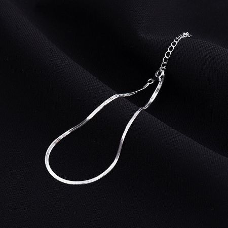 Flat lay of the 925 silver snake chain anklet set, showcasing the platinum and gold-tone options.