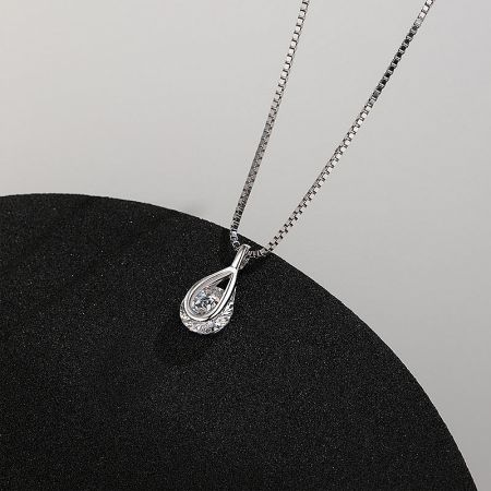 Detailed close-up of the teardrop pendant and its sparkling gemstone.