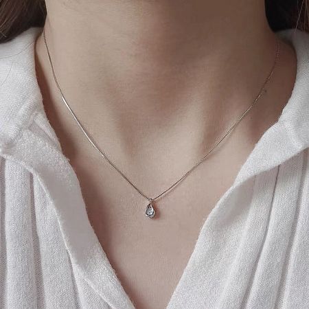 Model showcasing the sterling silver teardrop necklace with cubic zirconia.