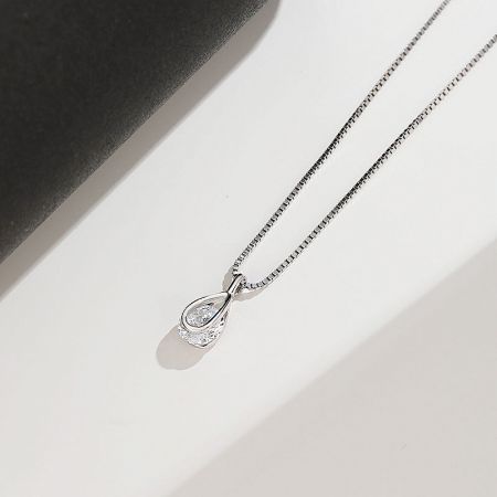 Angled view of the silver teardrop pendant necklace, highlighting its shine.