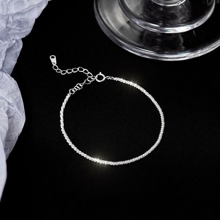 Detailed view of the textured sterling silver bracelet.
