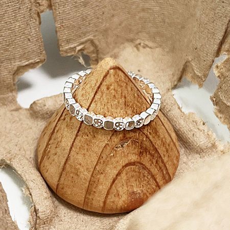 Detailed view of a sterling silver open ring with a unique textured square brick pattern.