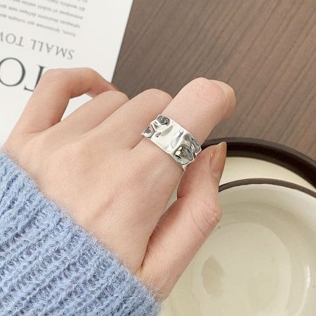 Top-down view of a silver textured geometric ring.