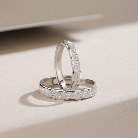 Detailed shot of the sterling silver promise rings, showcasing the unique sanded finish.
