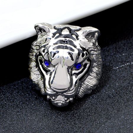 A silver tiger head ring showcasing the same bold design and blue eye detail.