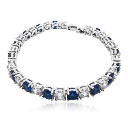 Sapphire White Wholesale Tennis Bracelet - A stunning Sapphire White Wholesale Tennis Bracelet with alternating round-cut blue sapphire and white cubic zirconia stones, set in a high-polish rhodium-plated silver-toned metal, shown on a clean white background.