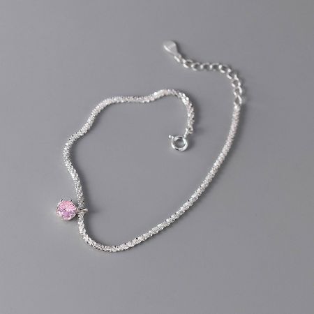 Side view of the pink zircon bracelet, highlighting the textured chain and secure clasp.