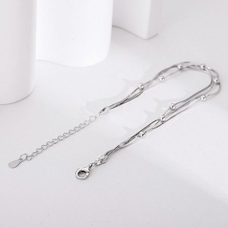 A single sterling silver multi-layer bracelet showing its intricate twisted design.