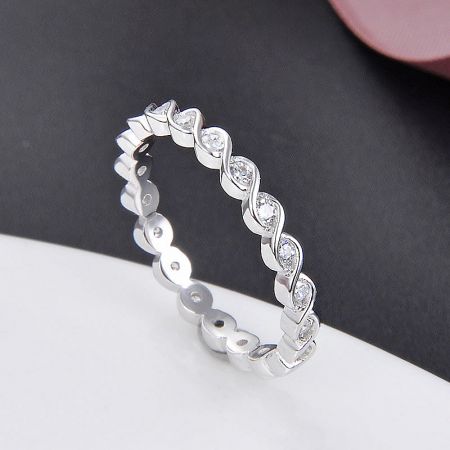 Another view of the sterling silver twist ring, emphasizing the sparkle of the embedded gemstones.