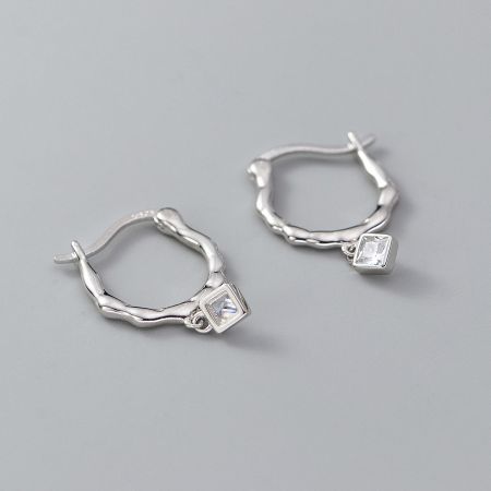 Another angle of the silver twist hoop earrings showing the secure setting of the square gemstone.
