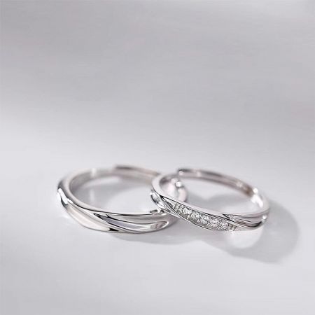 Close-up of the matching silver rings, highlighting the polished and pavé cubic zirconia bands.