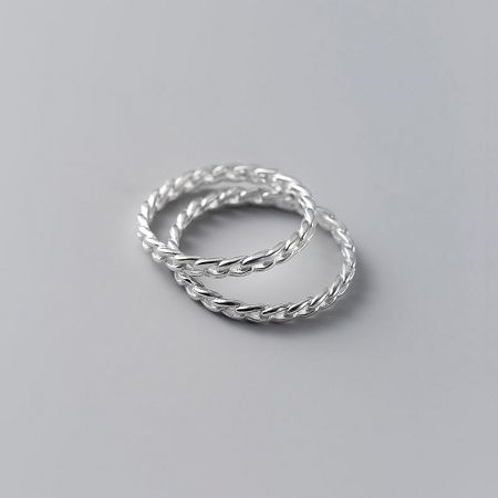 A sterling silver ring from the set with a delicate twisted design.
