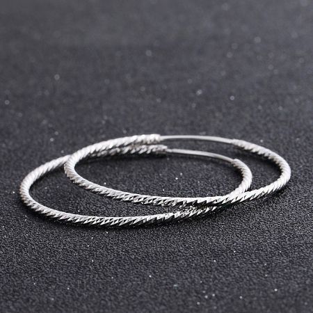 Detailed view of the unique textured finish on the 37mm sterling silver hoop earrings.