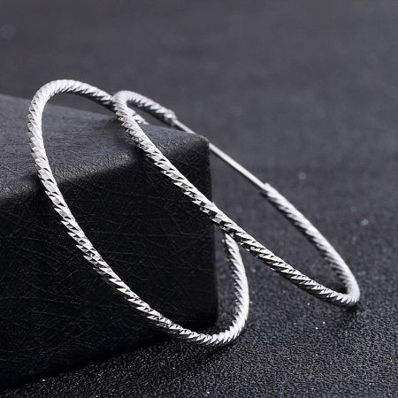 Side profile of the large 925 silver hoop earring, highlighting its secure piercing loop closure.