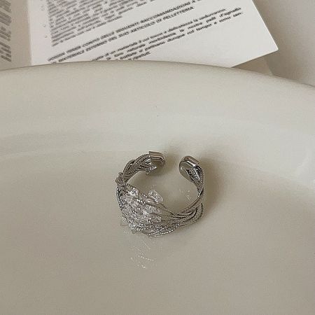 A third style from the wholesale set, featuring a bold, twisted wire-wrapped design around a central crystal.