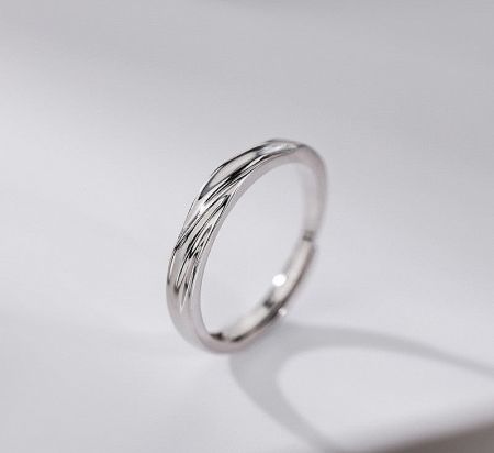 Detailed view of the sterling silver ring with its unique twisted wave design.