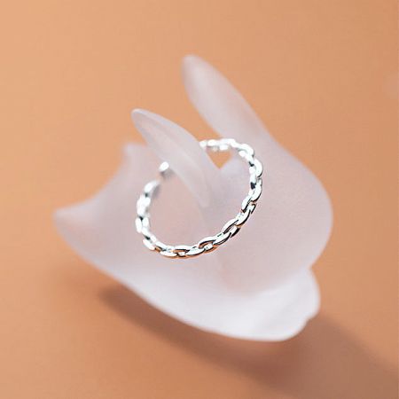 The adjustable sterling silver ring displayed on a mannequin hand, highlighting its unique twisted chain design.