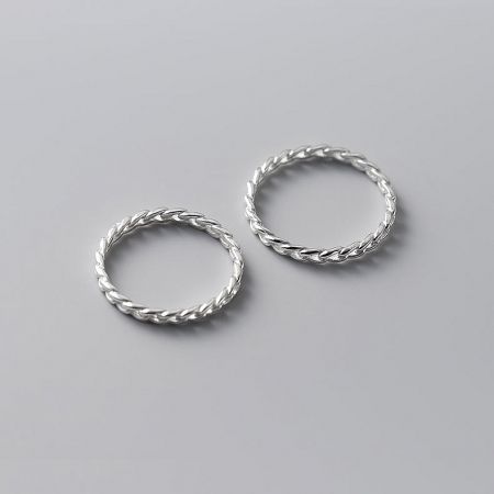 Two sterling silver rings with a twisted rope design, demonstrating their stacking potential.