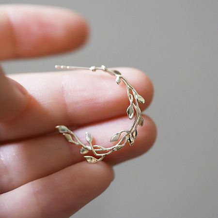 A close-up view of the silver version of the leaf stud earring, highlighting the detailed craftsmanship.